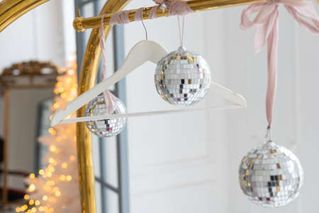 Elegant Christmas poster mockup with golden balls decorations and snowflakes on pastel beige backgroundの写真素材