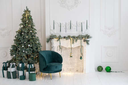 Christmas toys on a fir-tree close up with interior background of a luxury hotel apartmentの写真素材