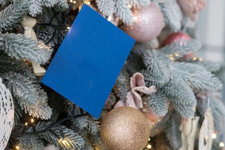 Closeup of Festively Decorated Christmas tree with bright balls on blurred sparkling fairy background. Defocused garland lights, Bokeh effect.の写真素材