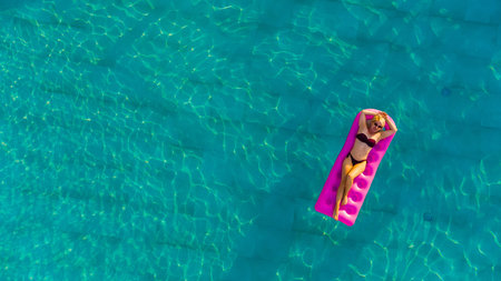 Young pretty woman with perfect body lying on air mattress