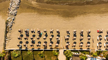 View to sandy beach of Adriatic Sea and to the city of Durres, Albania during sunset.の写真素材