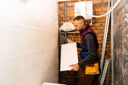 industrial tiler builder worker installing floor tile at repair renovation work.の写真素材