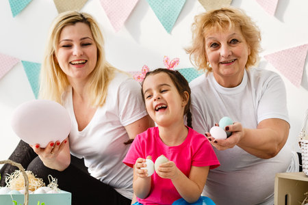 happy family with easter eggs. Happy llittle girl and grandmother with Easter eggs