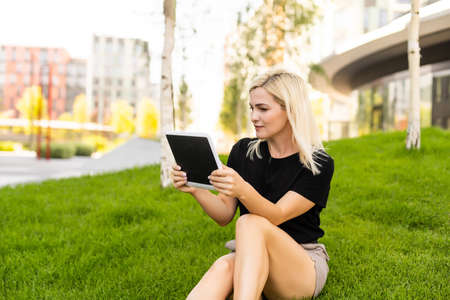 Happy young woman with digital tablet.の写真素材