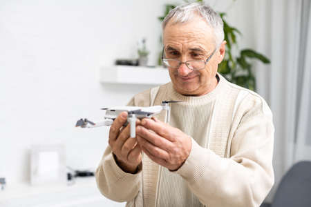 elderly man with small model airplaneの写真素材