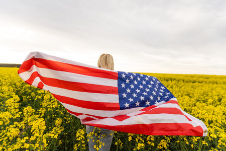 country, patriotism, independence day and people concept - happy smiling young woman with national...