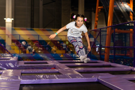 Positive funny girl in casual clothes jumping and smiling