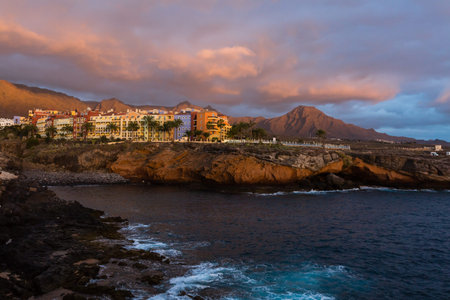 Panoramic view of the Illuminated Las Americas at night against the colorful sunset sky with lights...