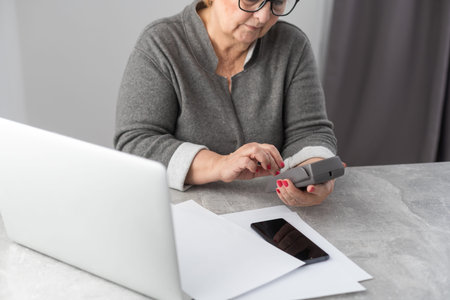 Retired woman calculating her domestic bills