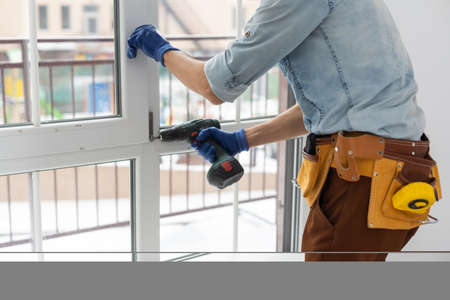 The worker installing and checking window in the houseの写真素材