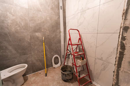 bathroom renovation and tiling. Laying floor ceramic tileの写真素材