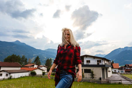 woman enjoying beauty of nature looking at mountain. Adventure travel, Europe. Woman stands on background with Alps.の写真素材