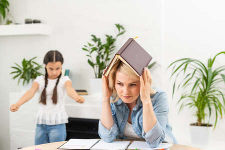 Angry daughter threatening her mother at homeの写真素材