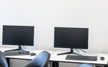 Laptop and landline phone on desk at office