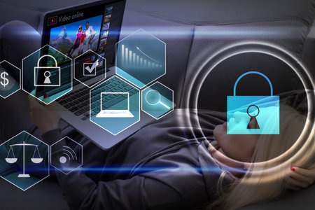 Businesswoman with laptop, desktop at office interior, blue glowing information protection icons....
