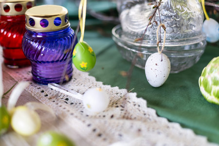 Painted Easter eggs and candles, multicolored, vintage, on a wood table