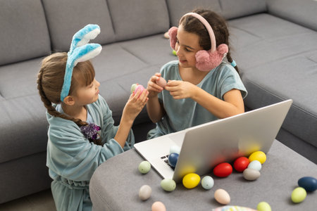 Girls demonstrating eggs and greeting with spring holidays online Eater celebration, craft for kids,...