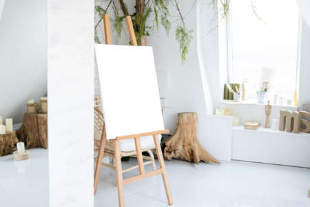 Easel with painting in artists workshopの写真素材