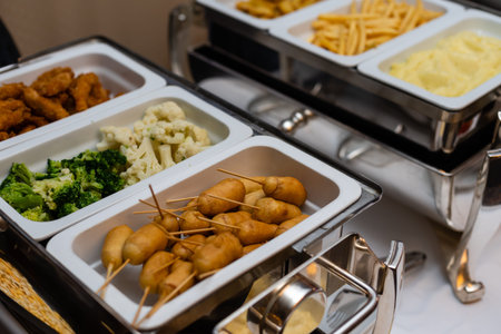 The salad buffet bar at the restaurant with lots of vegetables dishes.