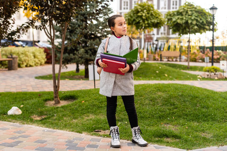 little schoolgirl in the autumn