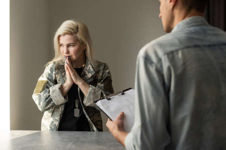 Military woman. Blonde experienced military woman suffering from insomnia coming to psychologist.の写真素材