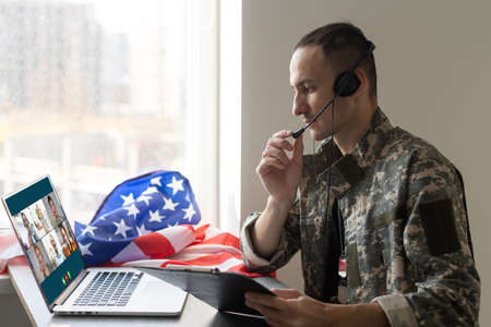 a army speaking video conferencing on computer using online video call consultation appの写真素材