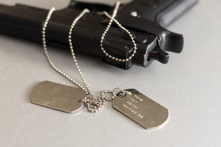 gun and dogtag isolated on a white background