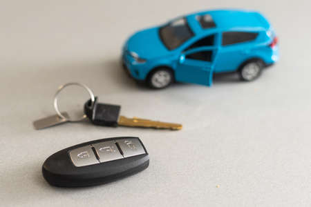 Toy car and keys car on white backgroundの写真素材