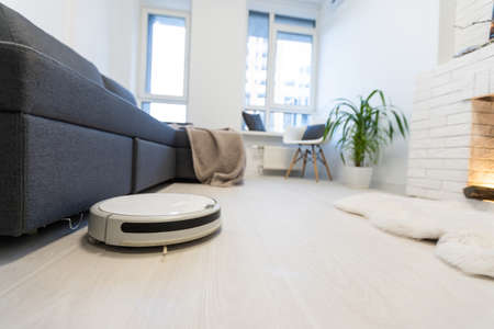 Robot vacuum cleaner performs automatic cleaning of the apartment at a certain time. Smart homeの写真素材
