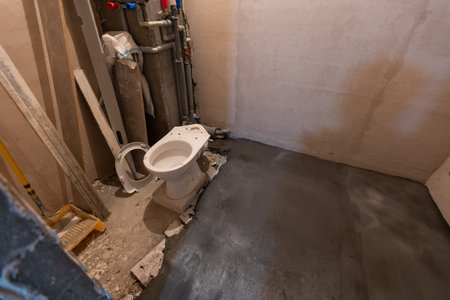 Toilet bowl in the bathroom. Repair. Sanitary ceramics. Plumbing. Water pipes. Plastic faucet. Floor standing toilet.の写真素材