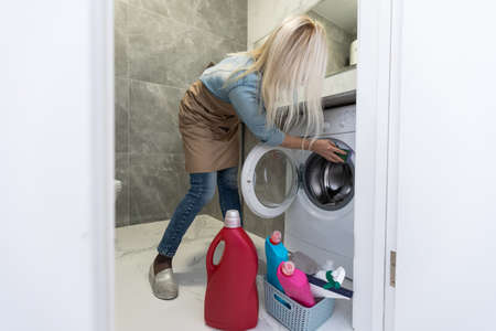 woman with cleaning equipment ready to clean house on bathroom backgroundの写真素材