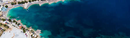 Relaxing aerial beach scene, summer vacation holiday template banner. Waves surf with amazing blue ocean lagoon, sea shore, coastline. Perfect aerial drone top view. Peaceful bright beach, seasideの写真素材