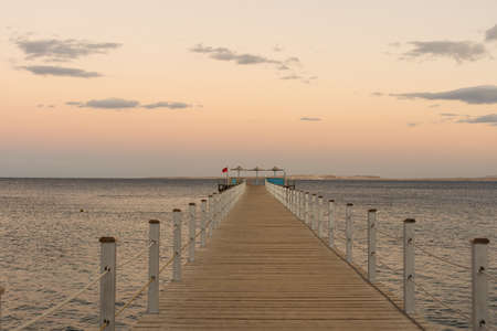 Golden sea sunset on the wooden pier.の写真素材