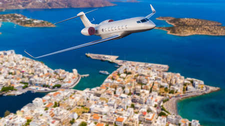Airplane landing above beautiful beach and sea backgroundの写真素材