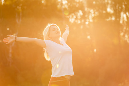 beautiful young blond woman alone in the park