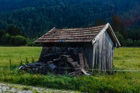 One wooden house in the fall on a hill in the mountains.の写真素材