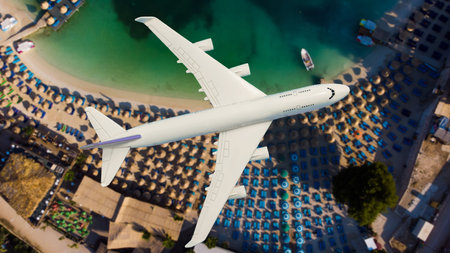 Airplane landing above beautiful beach and sea backgroundの写真素材
