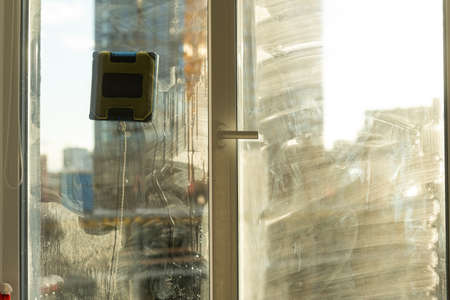 Window with very dirty and dusty glass in daylight. cleaning robotの写真素材