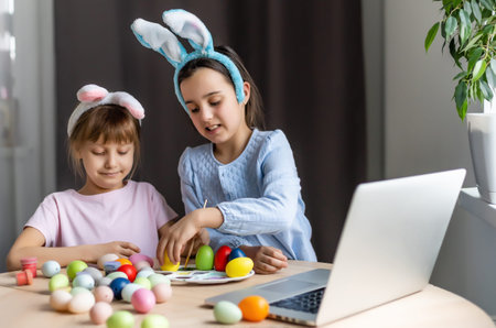 little girls for easter paint eggs, record lessons on web camera with laptop