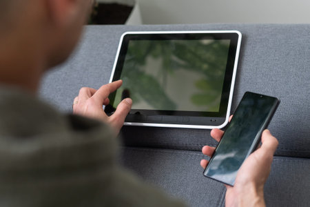 Digital tablet computer with isolated screen in male hands over cafe background