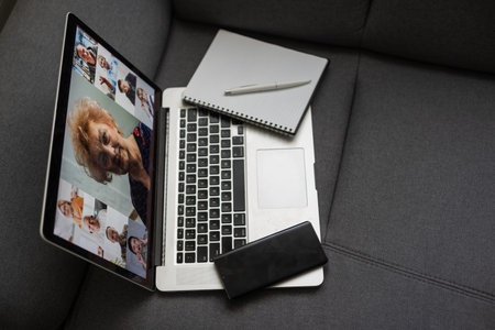 Laptop screen with multi-person conference, collage of group of multiracial people, webcam view,...