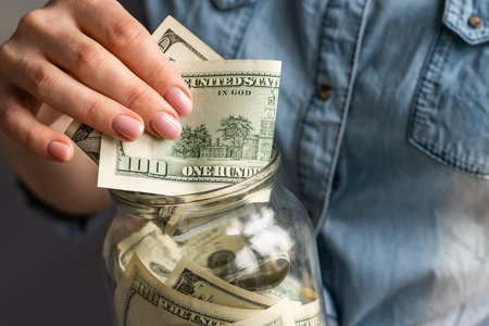 Hands holding 100 dollar bills. Mens hand holds a fan of dollars. Wealth, financial flows and...