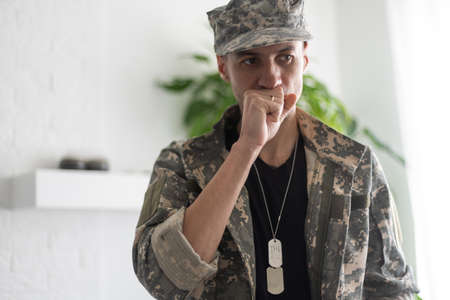 Soldier man isolated on white background is suffering with cough and feeling bad.の写真素材