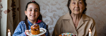 Easter concept. Grandmother with granddaughter are holding Easter eggs at home