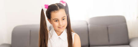 Homeschool little young kid girl learning piano from computer connecting to internet music online class by school teacher. New normal lifestyle and education, student study at home concept.の写真素材