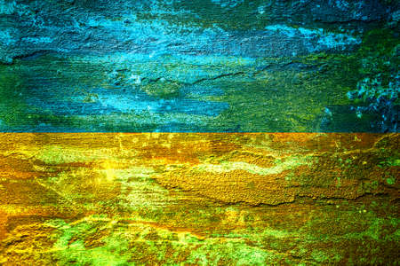 An old image of the flag of Ukraine on a wall with a crack. A crisis.の写真素材