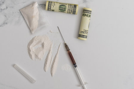 Drug heroin, syringes, money, guns on a dark background copy space, concept of crime and addictionの写真素材