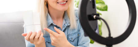 blogger woman records video with round lampの写真素材