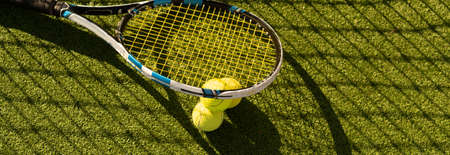 Tennis Ball with Racket on the racket in tennis courtの写真素材