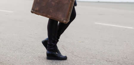 Ancient background, female legs, ancient road and suitcaseの写真素材